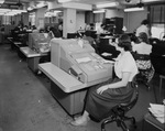 Employee working with an IBM proof machine by W. D. Smith