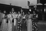 Moslah Shriners with a group of women at a train station by W. D. Smith