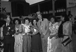 Moslah Shriners with a group of women at a train station by W. D. Smith