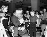 Christmas party, Santa Claus speaking to a young boy by W. D. Smith