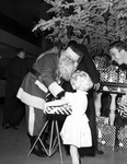 Christmas party, Santa Claus handing gift to a young girl by W. D. Smith