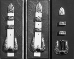 A photograph of three belt buckles and loops by W. D. Smith