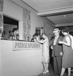 Guests in 1920s costume standing by the bar by W. D. Smith