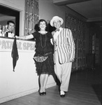 A couple in their 1920s costumes by the bar by W. D. Smith