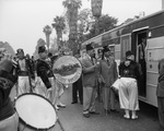 Group of Shriners gathered around travel trailer by W. D. Smith