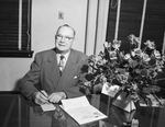 F. O. Shelton sitting at his desk by W. D. Smith