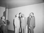 Group of six men standing in a room by W. D. Smith