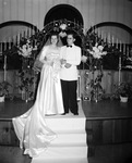 Bride and groom standing by the altar by W. D. Smith