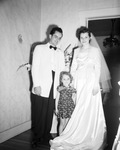 Bride and groom standing with young girl by W. D. Smith