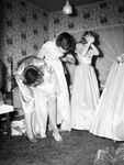 Bridesmaids and bride getting ready for wedding by W. D. Smith