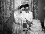 Bride and groom cutting the wedding cake by W. D. Smith