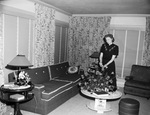 Mrs. W. D. Smith standing in a room with a floral arrangement by W. D. Smith