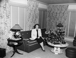 Mrs. W. D. Smith seated in a room with a floral arrangement by W. D. Smith