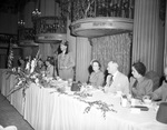 Group with Shriners in a dining room and seated at a speakers' table by W. D. Smith