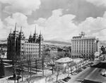 Birds-eye-view of several buildings and montains in the distance by W. D. Smith