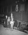 Moslah Potentate with family in front of train by W. D. Smith