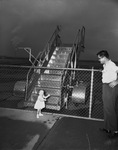 Nancy and father Gordon Smith waiting for plane by W. D. Smith