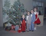 Children posing next to Christmas tree by W. D. Smith