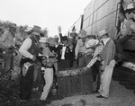 Men dressed as cowboys standing next to a train by W. D. Smith