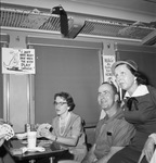 People sitting in train car by W. D. Smith