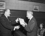 A man handing another man a certificate by W. D. Smith