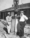 Men standing by an electric tower by W. D. Smith