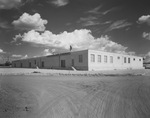 View of dirt road leading up to the exterior of the Gulf Building by W. D. Smith