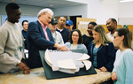 Professor Observing Building Model by University Photographer