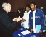 Student and Parent at UT Arlington Booth by University Photographer