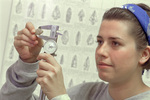 Student Measuring Arrowhead by University Photographer