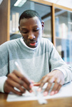 Student Studying Notes by University Photographer