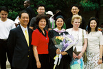 Student with family at graduation ceremony by University Photographer