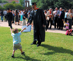 Student with his diploma by University Photographer