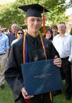 Student with his diploma by University Photographer